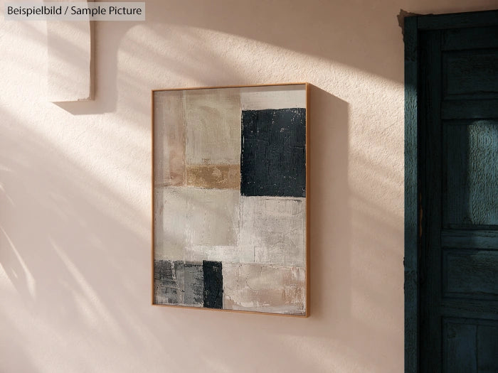 Abstract geometric painting with black and beige squares on a wall, next to a wooden door in sunlight.