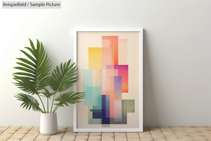 Framed abstract geometric art with pastel rectangles on a wall beside a potted plant.