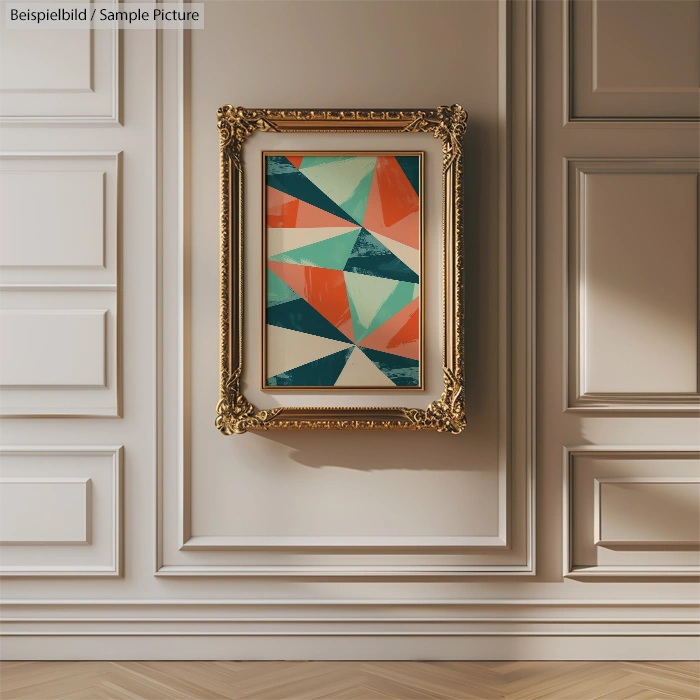 Abstract geometric painting in ornate gold frame on elegant white paneled wall.