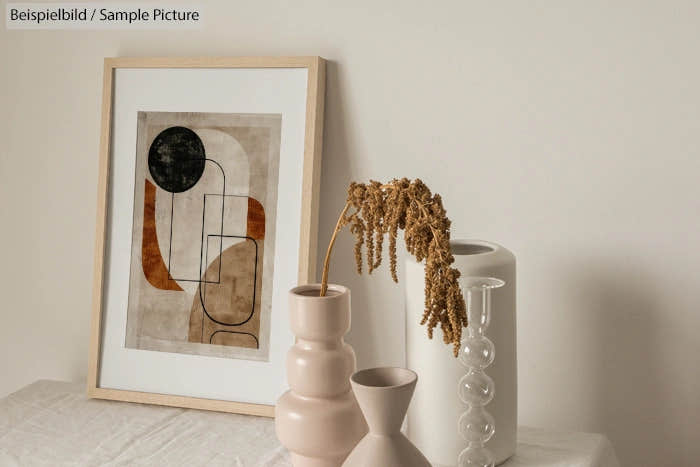 Minimalist interior with abstract artwork, ceramic vases, and dried flowers on a white shelf.