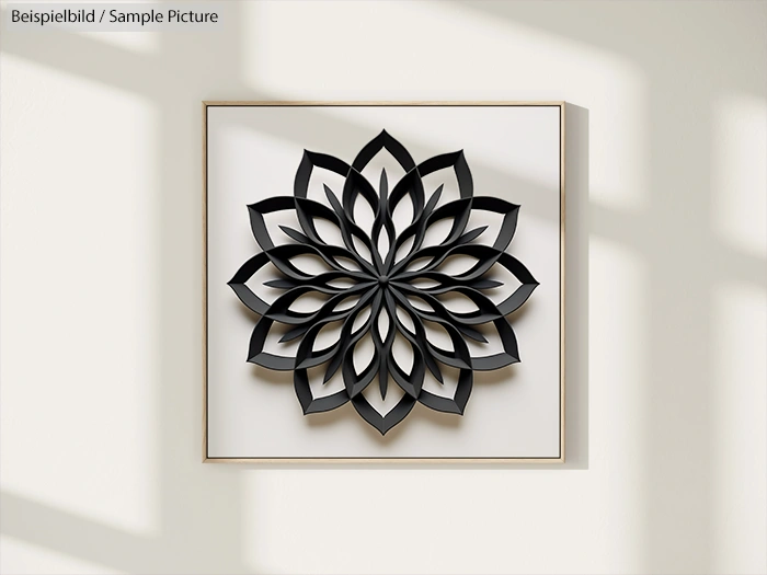 3D black floral wall art with geometric pattern in white frame, shadowed on a cream wall.