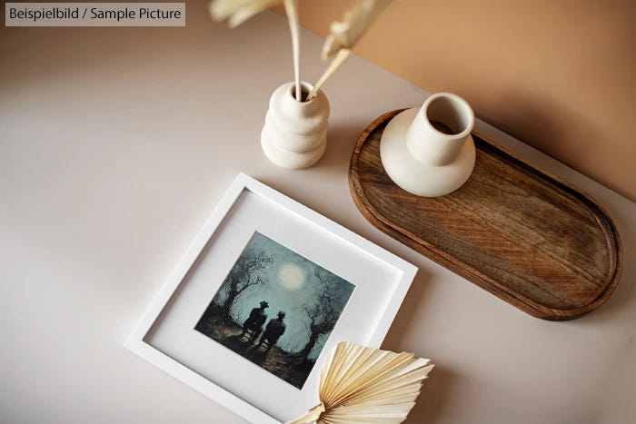 Minimalist decor with framed art, ceramic vases, and a wooden tray on a light-colored surface.