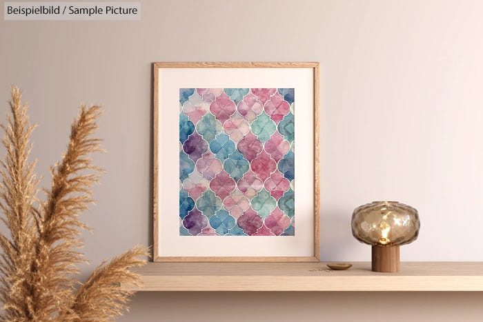 Colorful geometric pattern artwork in a wood frame on a minimalist shelf with decorative items.