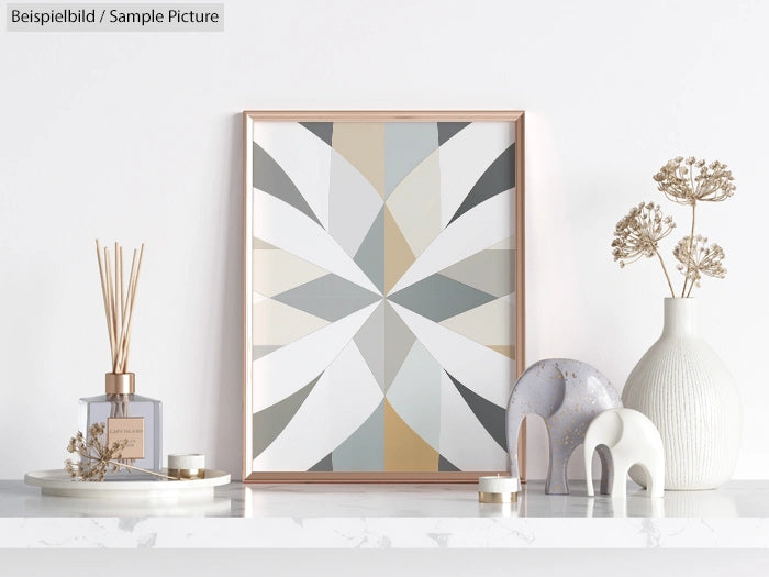 Modern geometric artwork in a frame on a white shelf with vases and decorative elephants.