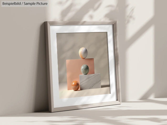 Minimalist art piece with three colored spheres on geometric pedestals in a modern frame, casting shadows on wall.