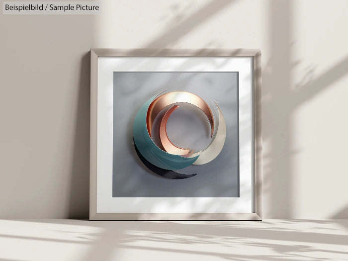 Framed abstract art with circular metal shapes in muted colors, displayed on a wall with shadow patterns.