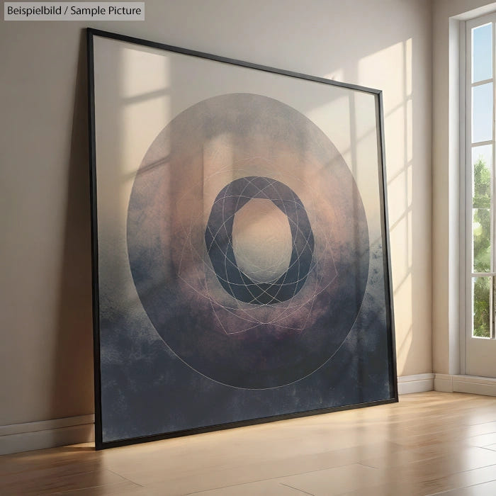 Framed abstract art with concentric geometric circles leaning against a sunlit wall.