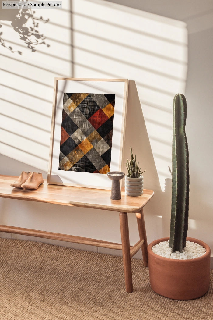 Minimalist room with framed abstract art, patterned rug, wooden bench, potted cactus, and sunlight casting shadows.