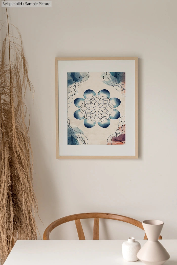 Framed geometric art print with blue and beige patterns on wall, next to decorative grasses and ceramic vases.