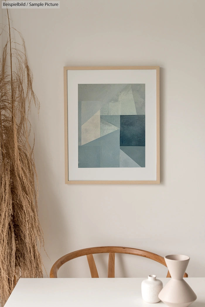 Minimalist interior with abstract geometric painting, dried grass arrangement, wooden chair, and ceramic vases on table.