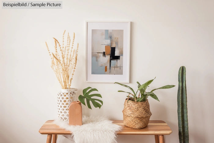 Minimalist room with abstract art, plants, and wooden bench against a light wall.