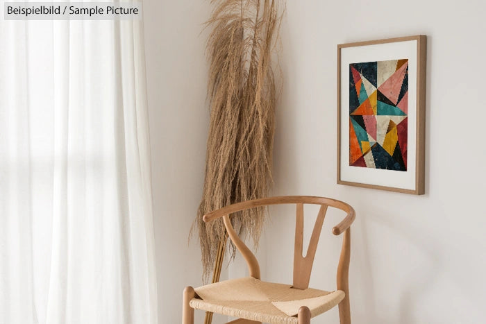 Minimalist room with wooden chair, abstract geometric painting, and dried grass decoration on a white wall.