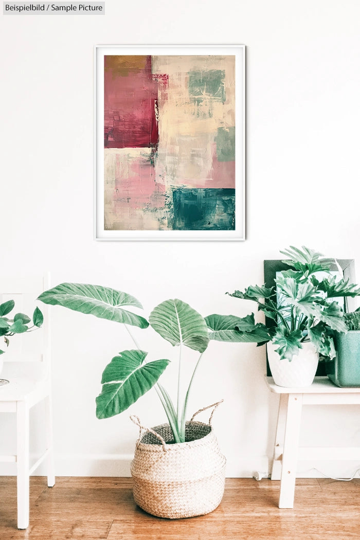 Abstract painting with pink, green, and beige tones in a white frame; plants in woven baskets in the foreground.