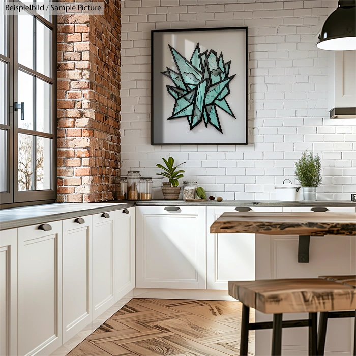 Modern kitchen with white cabinets, brick wall, and geometric art on the wall. Wooden countertops and flooring.