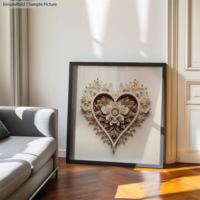 Elegant heart-shaped floral artwork in frame, resting on the floor by a modern sofa with wooden floor and window light.