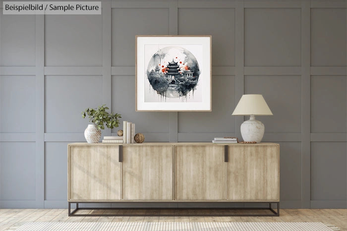 Minimalist living room with a wooden sideboard and framed Asian-inspired artwork on the wall.