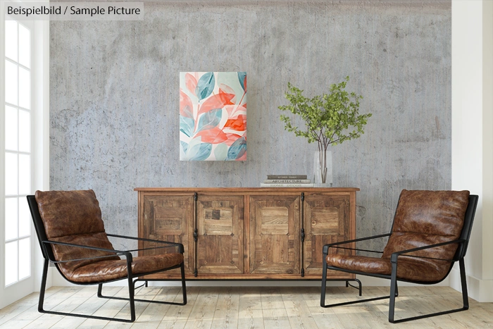 Modern living room with two leather chairs, a wooden cabinet, abstract artwork, and a potted plant against a gray wall.