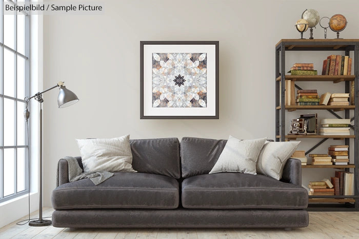 Modern living room with gray sofa, geometric art, and bookshelf with books and globe.