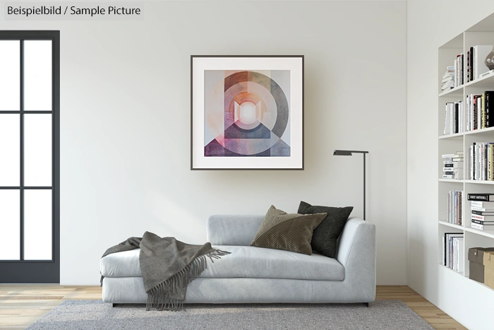 Modern living room with a grey sofa, abstract art on the wall, and shelves filled with books.