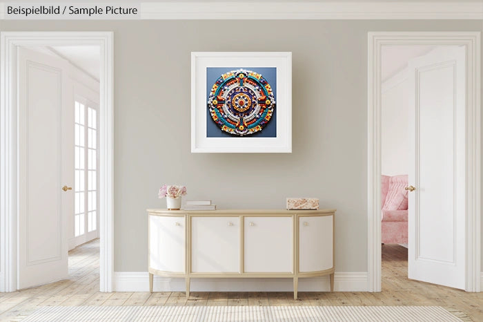 Modern living room with mandala artwork on the wall above a white console table.