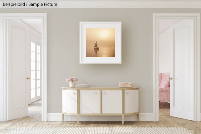 Elegant room with a console table, framed sailboat photo, and soft beige decor.