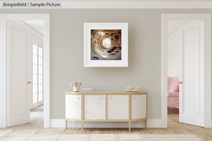 Elegant living room with minimalist white furniture and framed abstract artwork on beige wall.