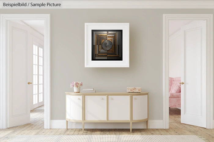 Minimalistic living room with abstract art on wall, light colored sideboard, and glass door to the left.