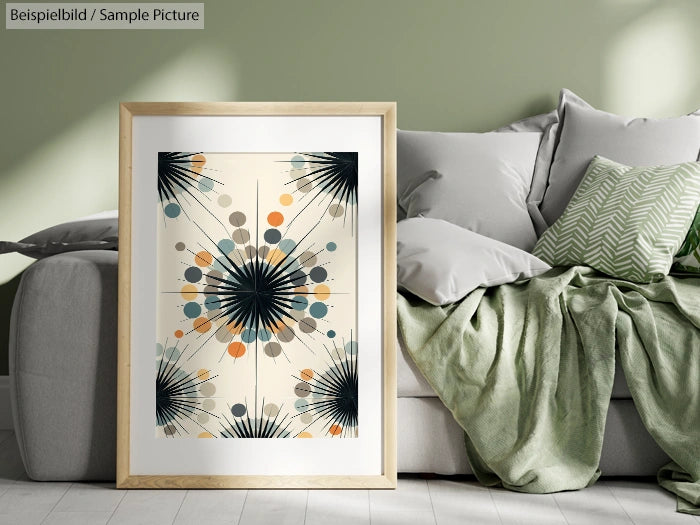 Framed abstract art with geometric design, plants, and colorful circles on a living room floor next to a green sofa.