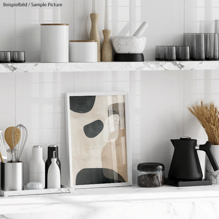 Modern kitchen shelves with decor items, jars, black kettle, and abstract artwork on marble countertop.