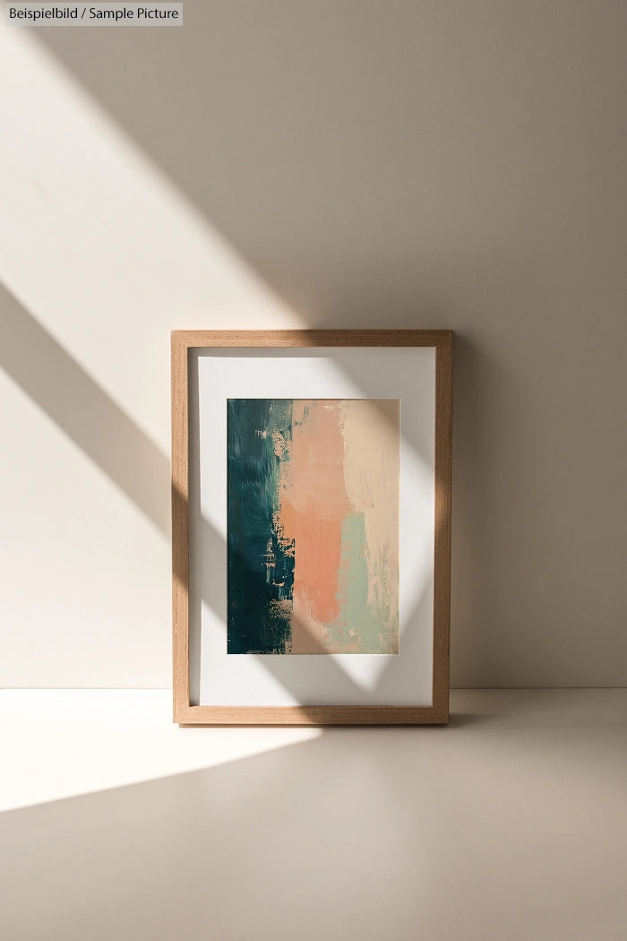 Framed abstract painting with dark green, orange, and beige vertical brushstrokes in sunlight.