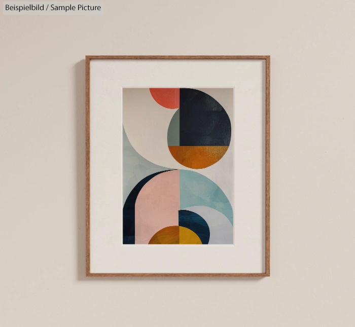 Framed abstract art with geometric shapes in blue, pink, and orange on a beige wall.