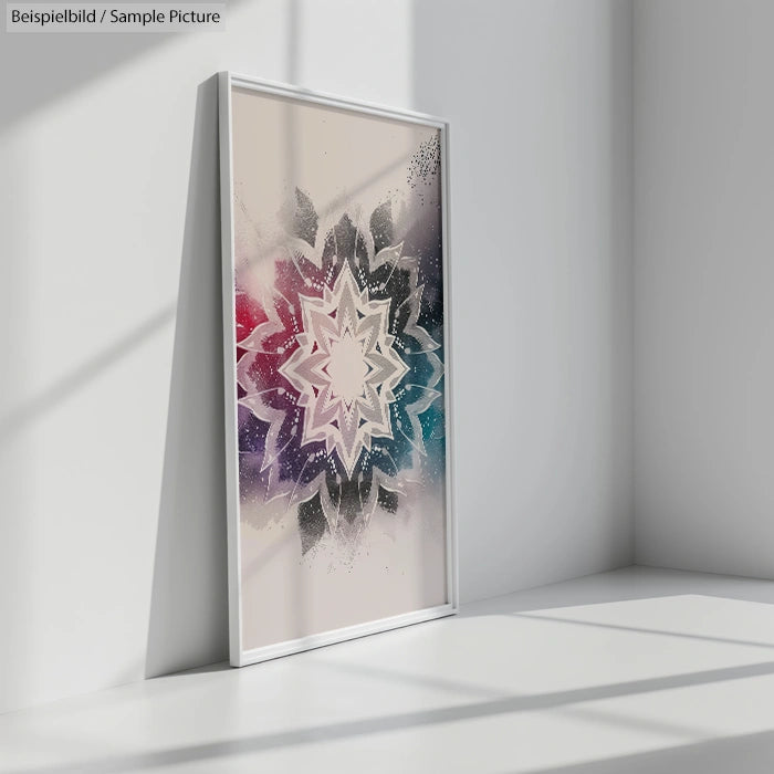 Framed geometric art with starburst pattern in red, purple, and blue, casting a shadow on a white wall corner.