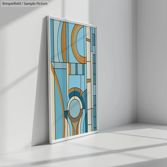 Framed abstract painting with geometric shapes in blue and beige leaning against a wall in a sunlit room.