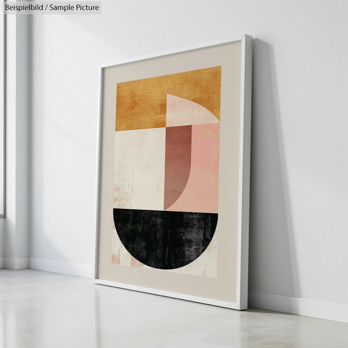 Abstract geometric artwork with semicircles and rectangles in beige, pink, and black, framed and leaning against a wall.