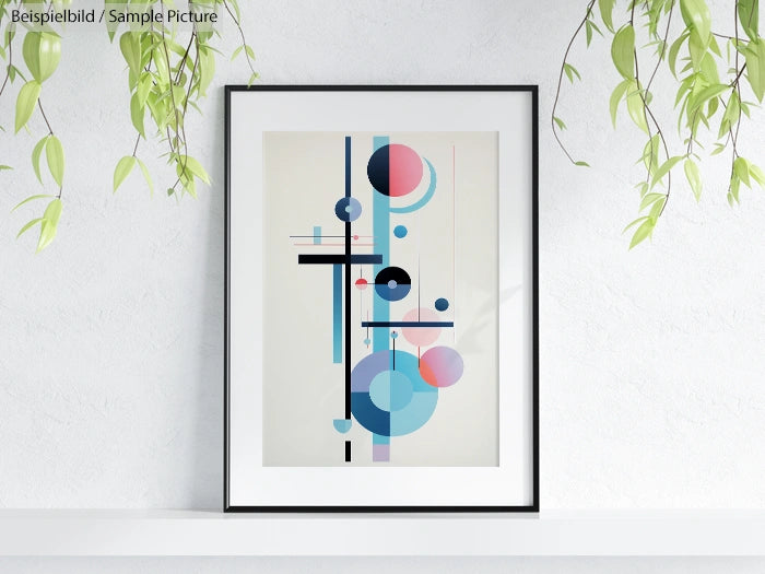 Modern abstract art with geometric shapes in blue, pink, and black, framed and hanging on a white wall with plants.