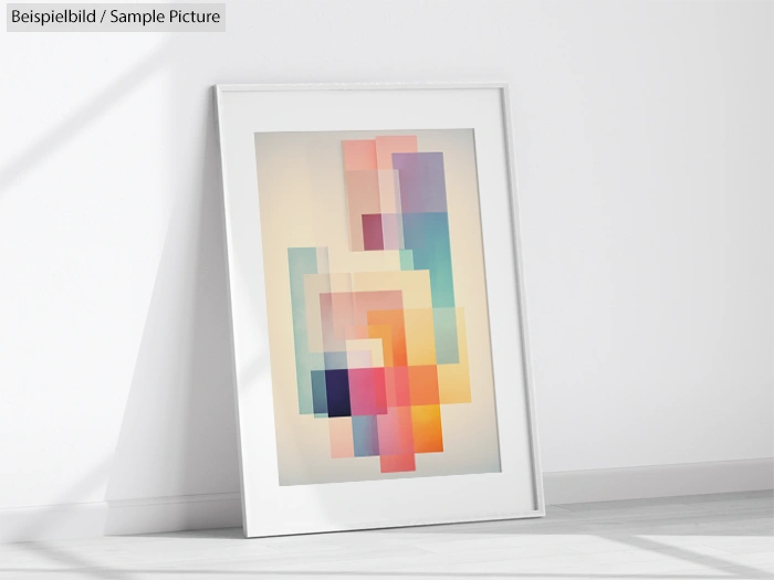 Framed abstract art with overlapping pastel blocks placed on a white wall.