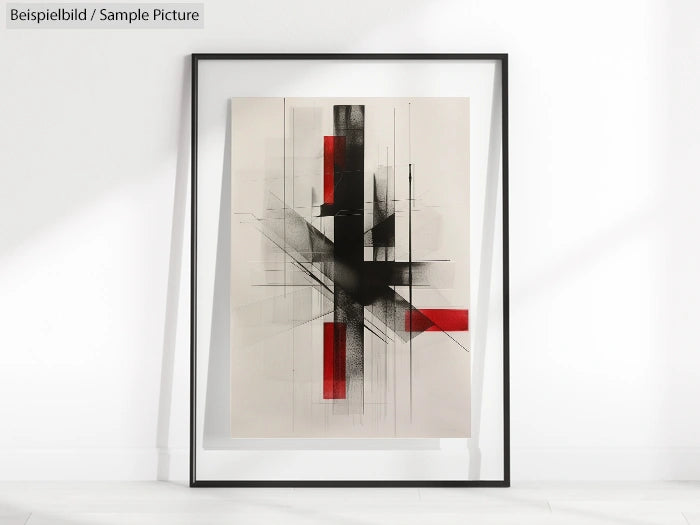 Framed abstract print with black geometric lines and red rectangles on a light background, leaning against a wall.