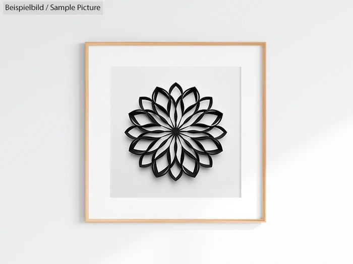 Framed wall art featuring a symmetrical black petal pattern on white background.