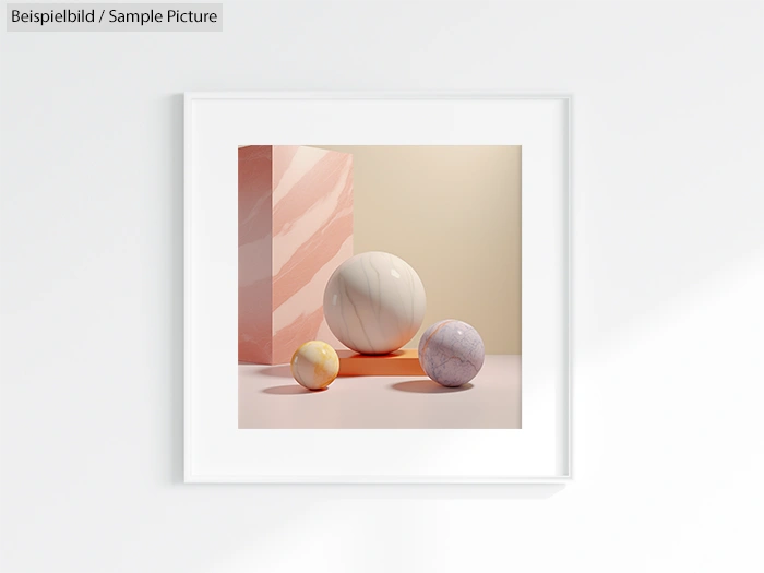 Framed artwork of three marble spheres on a reflective surface, with a pink and beige background.