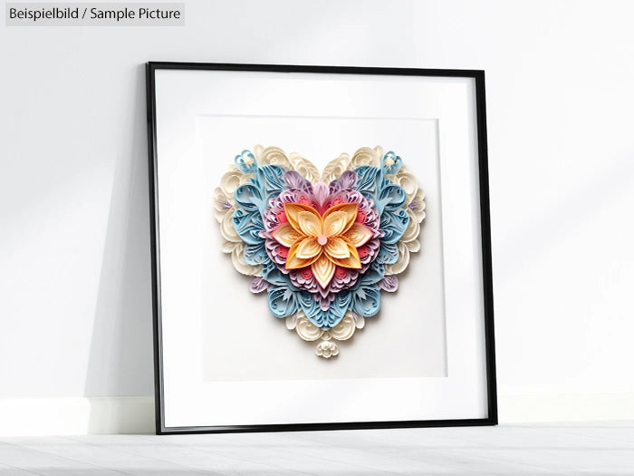 Framed paper quilling art depicting a colorful heart with intricate floral patterns, displayed on a light-colored floor.