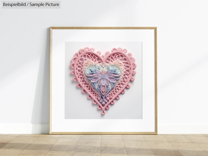 Decorative crocheted heart frame with pastel pink and blue patterns, displayed against a white wall.