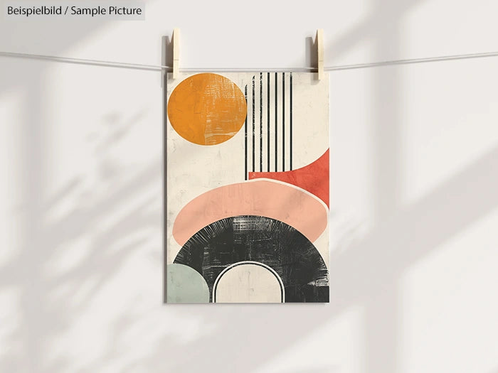 Abstract artwork with geometric shapes in orange, red, pink, and black on a hanging poster.