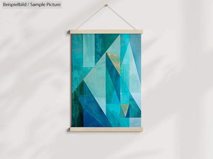 Geometric abstract art with blue and teal triangles, framed and hung on a white wall.