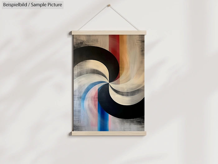 Abstract painting with swirling black, beige, and blue shapes on a white wall, framed and hung by a thread.