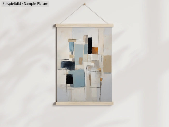 Abstract wall art with geometric shapes in shades of blue, black, and beige, hanging on a light-colored wall.