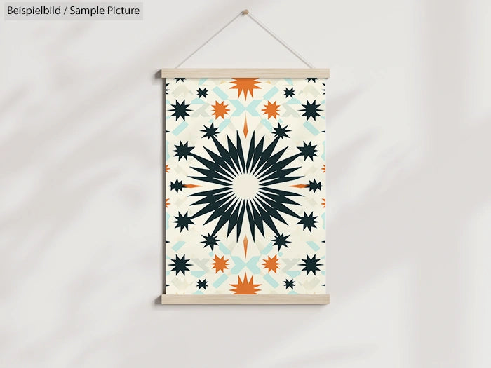 Geometric wall art with starburst pattern in black, orange, and blue on a white background.