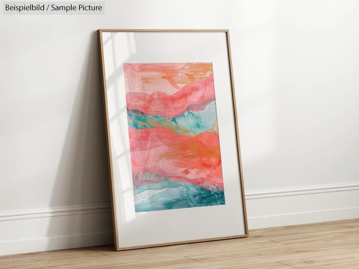 Framed abstract painting with pink, orange, and teal swirls leaning against a white wall on wooden floor.