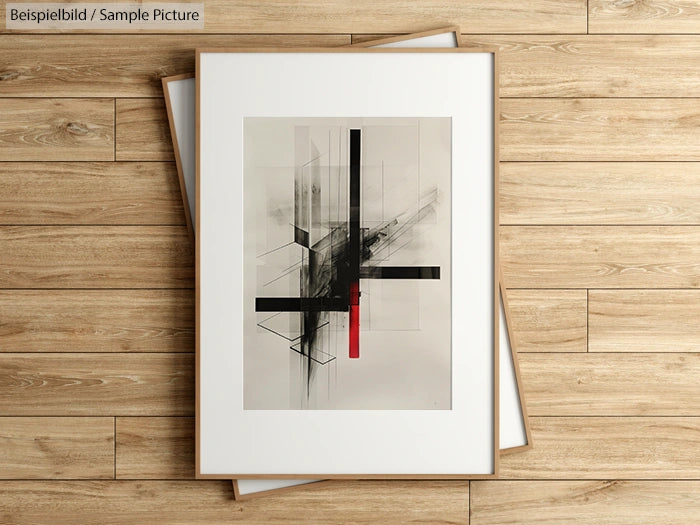 Framed abstract painting on wooden floor, featuring black, white, and red geometric shapes.