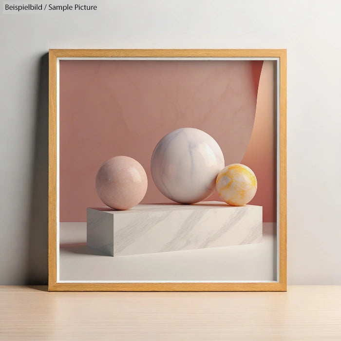 Framed art with three marbled spheres on a stone block against a soft pink background.