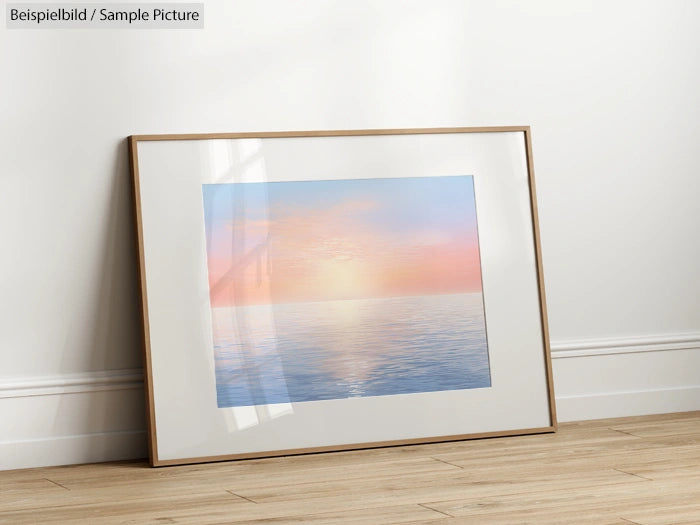 Framed painting of calm ocean with pastel sunset colors, leaning against a white wall on wooden floor.